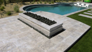 Pool deck constructed from patio pavers in luxury home backyard